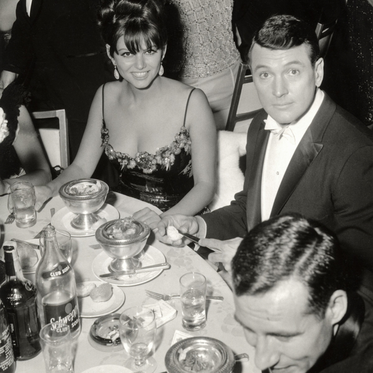 Photo of Claudia Cardinale and an apparently surprised Hudson at a dinner in the '60s.